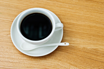 Top view of hot coffee on wooden table