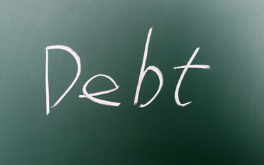 Debt word written on chalkboard