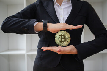 young investor holding a coin cryptocurrencies Bitcoin in hand with confidence in the coin...