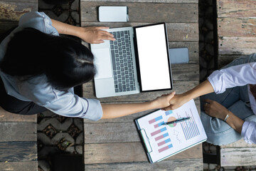 Smooth Focus, The young businessman is talking to an advisor to understand his new investment and handshake with an advisor to congratulate his adviser on making the business a success.