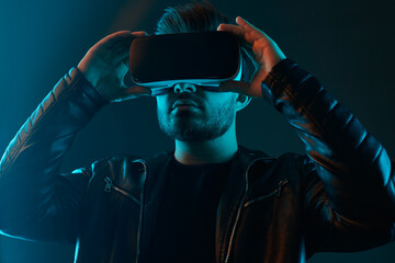 Man in VR glasses in dark studio
