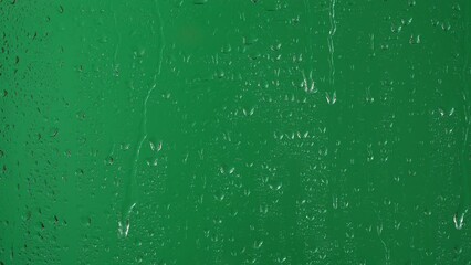 Water rainfall, rain drops falling on window glass over chroma key green screen - Powered by Adobe