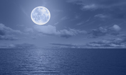 Moon rise in the clouds over the sea at night  "Elements of this image furnished by NASA