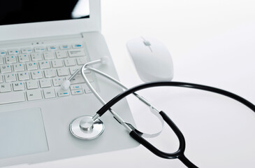 Stethoscope on the keyboard of laptop