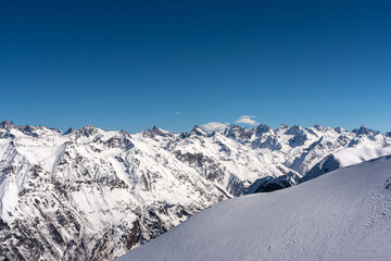 Obraz premium Mountain peaks covered with snow in winter. Mountain range in Caucasus region in Russia
