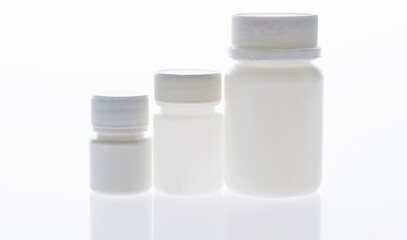 Three medicine bottles in a row isolated on white background