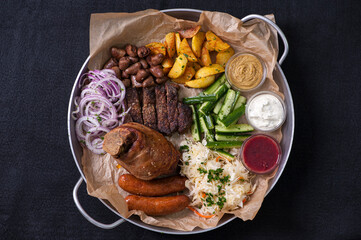 roast pork with potatoes and vegetables