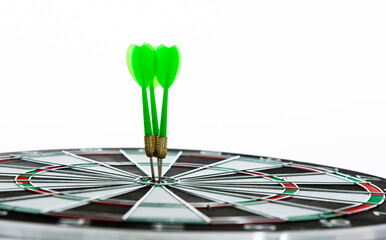 Three green dart arrows hitting in the target center