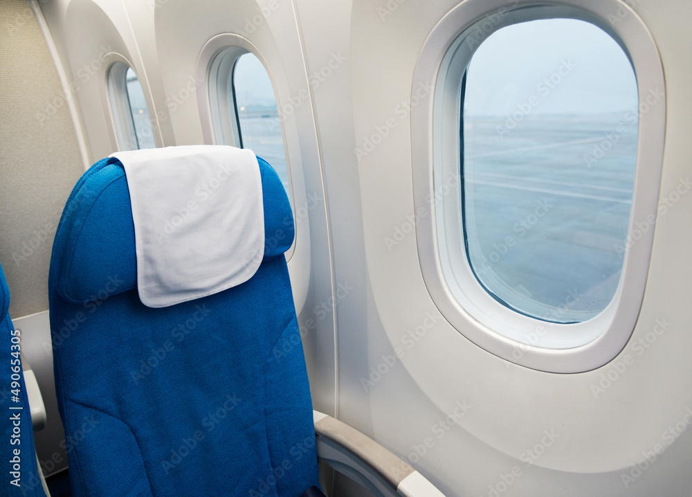 Wall mural empty seat and window inside an aircraft