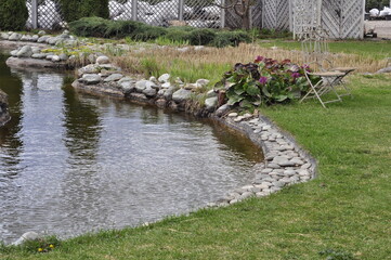 Garden pond. Pond in landscape design.