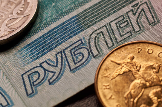 Banknotes and coins of the Russian ruble. Details of Russian money in close-up. The inscription rubles on a paper bill