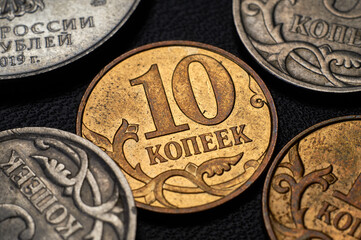 Banknotes and coins of the Russian ruble. Details of Russian money in close-up.The inscription 10...
