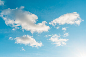 Naklejka na ściany i meble Nice cloudscape white fluffy clouds in the blue sky.Blue sky background with clouds