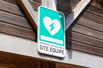 dae logo sign and french text automated external defibrillator place on public street