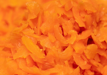 Orange boiled carrots as a background.