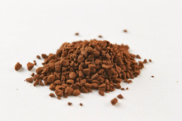 instant coffee granules on a white background
