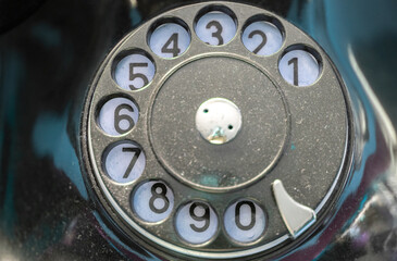 Close up of black  retro telephone dialer circle with numbers - obrazy, fototapety, plakaty