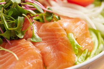 Vegetable salad over fresh salmon