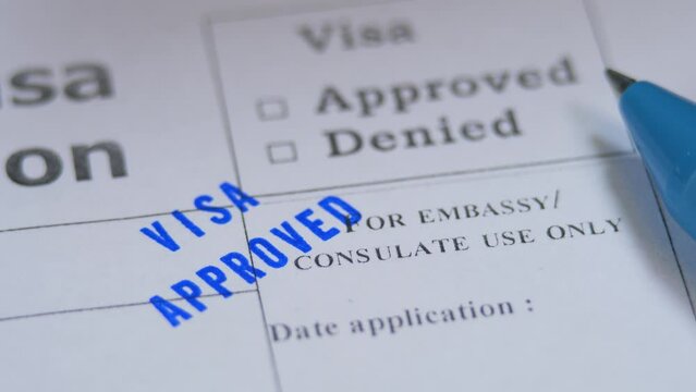 Approved stamp in paper visa application. Spend vacation abroad. Visa opened. Permission for emigration in foreign country. Success interview in embassy. Blue pen
