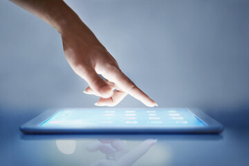 Intuitive technology. Cropped closeup of a womans hand above a digital tablet.