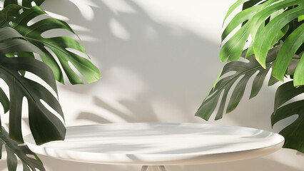 White round ceramic side table with green tropical monstera plant leaves with beautiful sun light...
