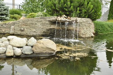 Garden pond. Pond in landscape design.