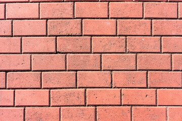 red colored brick wall of building facade background close up view