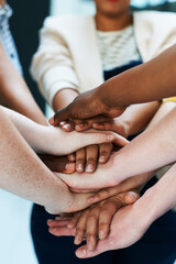 United as a team. Shot of a group of people putting their hands together.