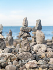 nature, harmony and balance - close up of stone pyramids or towers on beach