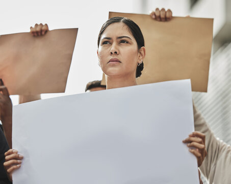 Shes Ready To Fight. Low Angle Shot Of An Attractive Young Woman Holding A Sign While Taking Part In A Political Rally.