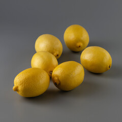 yellow lemons on a gray background, square format, close-up