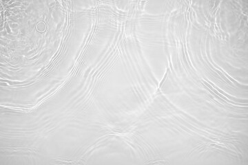 Desaturated transparent clear calm water surface texture with ripples, splashes Abstract nature background. White-grey water waves in sunlight Copy space Cosmetic moisturizer micellar toner emulsion
