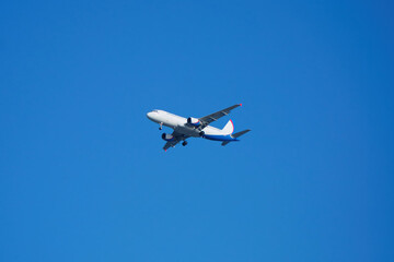Fototapeta na wymiar Flying in the blue; cloudless sky plane