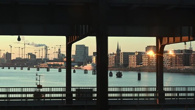 Slow motion video from a train crossing the Elbbruecken bridge over the river Elbe at Hamburg, Germany, Showing the panorama of Hamburg with the new district Hafencity.