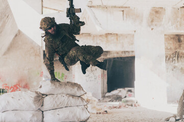 A bearded soldier in uniform of special forces in a dangerous military action in a dangerous enemy area. Selective focus 