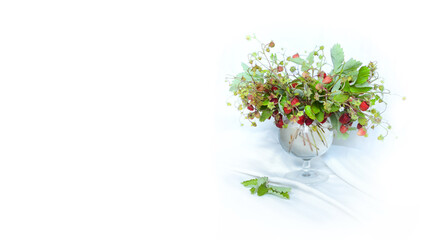 Bunch of strawberries with flowers, strawberry bouquet on white background, copy space