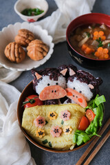 Homemade Japanese meal. Animated Shape Ox Onigiri Bento in Black and White Rice. Fun to make and healthy to eat
