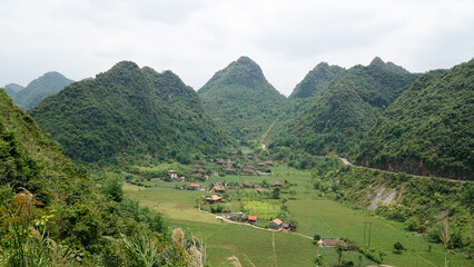 Fototapeta na wymiar Green hill and mountains near rice fields in Bac Son Valley, Vietnam.
