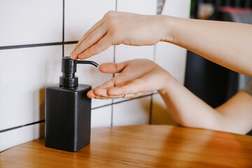 Man hands using wash hand alcohol gel or sanitizer bottle dispenser, against coronavirus (Covid-19) at cafe before meal. Antiseptic, Hygiene and Health concept