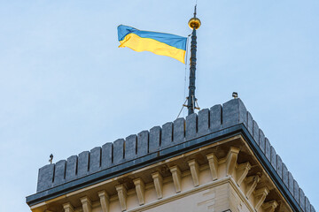 The tower of City Hall. Lviv, Ukraine. Clock tower. Ukrainian flag.