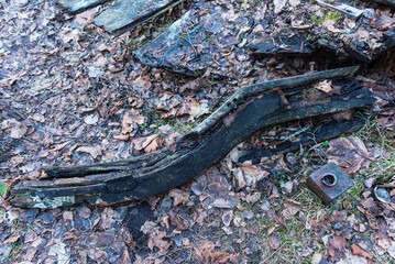 Old abandoned wooden fishing boat in the forest. Boat cemetery.