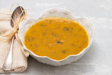 vegetable soup with spinach in beautiful bowl and spoon