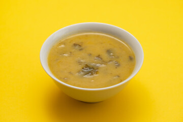 vegetable soup with spinach in beautiful bowl and spoon