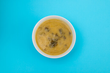 vegetable soup with spinach in beautiful bowl and spoon