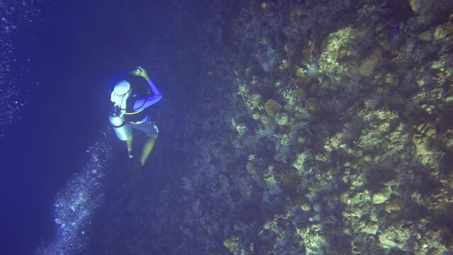 diver swim near the coral reef. Maldives