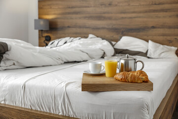Bedroom interior and breakfast on bed 
