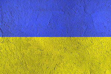 A cement wall painted in the blue and yellow colors of the Ukrainian flag