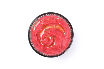 Bowl of beet hummus isolated on white background