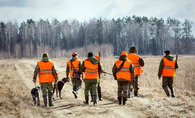  Hunters with dogs go to the forest during the hunting season © Zhanna