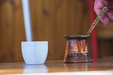 Serving traditional Greek coffee with a greek copper pot